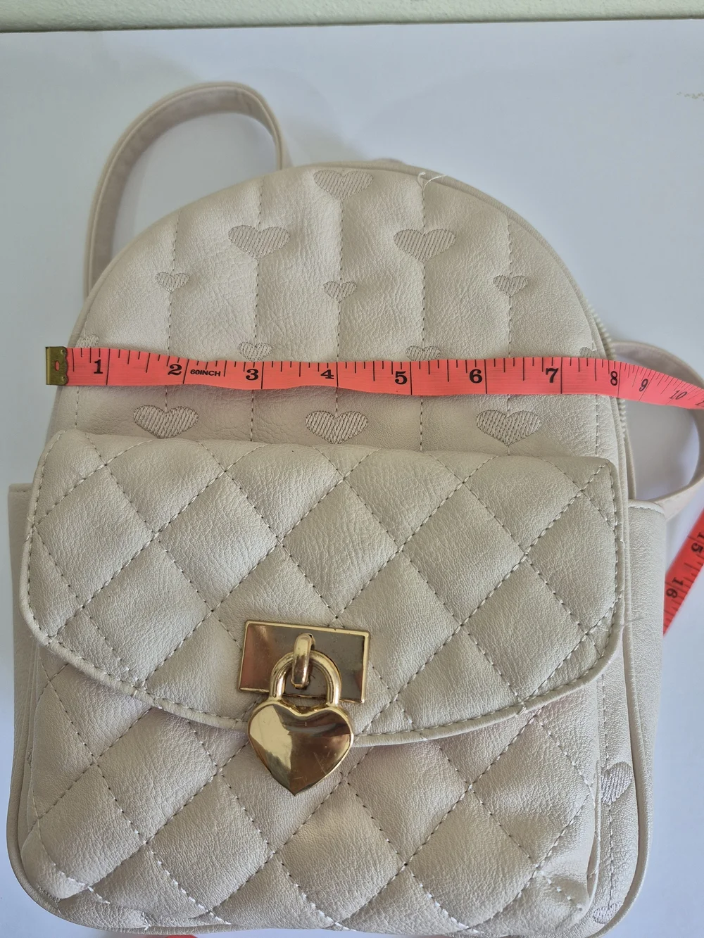 Under One Sky Cream Quilted Backpack with Gold Heart Lock